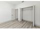 Bedroom featuring a closet with bi-fold doors, light grey laminate flooring and white walls at 8015 Sw 133Rd Ln, Ocala, FL 34473