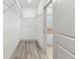 Walk-in closet featuring wire shelving, light gray floors and bathroom access at 8015 Sw 133Rd Ln, Ocala, FL 34473
