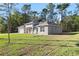 Side angle of charming home with a well-kept lawn, and an attached garage at 8015 Sw 133Rd Ln, Ocala, FL 34473