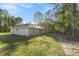 Back of home showing the spacious yard and exterior with multiple windows at 8015 Sw 133Rd Ln, Ocala, FL 34473