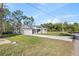Attractive home with a paved driveway and landscaped front yard on a sunny day at 8015 Sw 133Rd Ln, Ocala, FL 34473