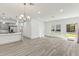Spacious open-concept living area featuring hard surface floors and contemporary lighting fixtures at 8015 Sw 133Rd Ln, Ocala, FL 34473