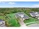 Stunning aerial view of a home with a lush lawn, complemented by mature trees and impeccable landscaping at 8614 Hata St, Orlando, FL 32827