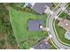 Aerial view of a home featuring a spacious yard, complemented by trees and a nearby roadway at 8614 Hata St, Orlando, FL 32827