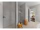 Bright bathroom showcasing a tiled walk-in shower and a view into the main bedroom at 8614 Hata St, Orlando, FL 32827