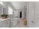 Modern bathroom featuring a soaking tub, double vanity, and a glass-enclosed shower at 8614 Hata St, Orlando, FL 32827