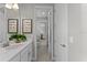 A hallway view of the bright bathroom showcasing a white vanity and an inviting hallway at 8614 Hata St, Orlando, FL 32827