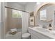 Bright bathroom with a shower-tub combination, white vanity, and modern fixtures at 8614 Hata St, Orlando, FL 32827
