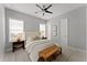 Cozy bedroom featuring a ceiling fan, a comfortable bed, and ample natural light at 8614 Hata St, Orlando, FL 32827