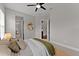 Comfortable bedroom with a ceiling fan, windows, and warm neutral decor at 8614 Hata St, Orlando, FL 32827
