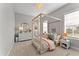 Bright bedroom with a four-poster bed, neutral decor, and plenty of natural light at 8614 Hata St, Orlando, FL 32827