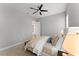 Comfortable bedroom featuring a ceiling fan, a plush bed, and soft neutral colors at 8614 Hata St, Orlando, FL 32827