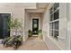 Picturesque courtyard entrance featuring brick pavers and lush landscaping around the windows at 8614 Hata St, Orlando, FL 32827