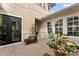 Inviting courtyard featuring brick pavers, a seating area, and a view of the home's facade at 8614 Hata St, Orlando, FL 32827