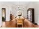 Elegant dining room with a large wooden table, stylish lighting, and views of the outdoor patio at 8614 Hata St, Orlando, FL 32827