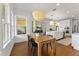 Dining room with hardwood floors, large windows, an elegant light fixture, and an open concept design at 8614 Hata St, Orlando, FL 32827