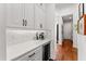 Kitchen area features wine fridge, quartz counters, mosaic tile backsplash, and stainless coffee maker at 8614 Hata St, Orlando, FL 32827
