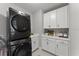 Well-equipped laundry room featuring a modern washer and dryer and ample storage space at 8614 Hata St, Orlando, FL 32827