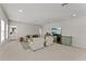 Open living area with comfortable seating, a large television, and neutral decor at 8614 Hata St, Orlando, FL 32827