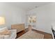Bright living room with wood floors, white walls, French doors and comfortable seating at 8614 Hata St, Orlando, FL 32827