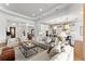 Open-concept living area with modern furnishings, neutral decor, and seamless flow into the kitchen at 8614 Hata St, Orlando, FL 32827