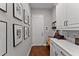 Mudroom features white cabinetry, long counters, framed art and access to the garage and backyard at 8614 Hata St, Orlando, FL 32827