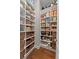Walk-in pantry with an abundance of shelving, woven baskets, and hardwood floors at 8614 Hata St, Orlando, FL 32827