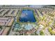 Panoramic aerial view showcases a large lake, resort pool, and extensive residential development at 8879 Geneve Ct, Kissimmee, FL 34747