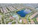 An aerial view shows a Gathering-friendly community featuring a large lake, pool area, and ample green spaces at 8879 Geneve Ct, Kissimmee, FL 34747