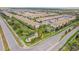 A beautiful aerial view of the townhomes in the Windsor community with manicured lawns, landscaping and roadways at 8879 Geneve Ct, Kissimmee, FL 34747