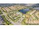 An aerial view of a residential area featuring a pool, lake with fountain, tennis courts, and clubhouse for residents at 8879 Geneve Ct, Kissimmee, FL 34747