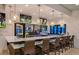 The community bar features a sleek marble countertop, pendant lighting, and TVs for residents' entertainment at 8879 Geneve Ct, Kissimmee, FL 34747