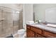 Bathroom features a glass-enclosed shower and granite countertops with wooden cabinetry at 8879 Geneve Ct, Kissimmee, FL 34747