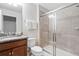 Bathroom with a glass shower and granite countertops with a wood vanity at 8879 Geneve Ct, Kissimmee, FL 34747