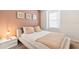 Bedroom with a neutral color scheme, a white comforter, and decorative wall art at 8879 Geneve Ct, Kissimmee, FL 34747