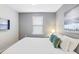 Cozy bedroom featuring a queen bed with a white comforter and a wall-mounted TV at 8879 Geneve Ct, Kissimmee, FL 34747