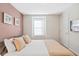 Bedroom with a neutral color scheme, a window, and decor wall art at 8879 Geneve Ct, Kissimmee, FL 34747