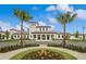 Elegant clubhouse featuring well-manicured landscaping and two palm trees accenting the entrance at 8879 Geneve Ct, Kissimmee, FL 34747