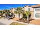 Beautiful townhome with mature landscaping, a paved driveway, and lush palm trees at 8879 Geneve Ct, Kissimmee, FL 34747