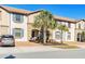 A lovely townhome boasts charming curb appeal with lush palm trees at 8879 Geneve Ct, Kissimmee, FL 34747