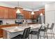 Well-lit kitchen area with granite countertops, stainless steel appliances, and barstool seating at 8879 Geneve Ct, Kissimmee, FL 34747
