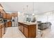 Open concept kitchen featuring a large center island, stainless steel appliances, and seating for casual dining at 8879 Geneve Ct, Kissimmee, FL 34747