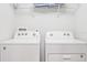 A well-equipped laundry area featuring a modern washer and dryer at 8879 Geneve Ct, Kissimmee, FL 34747