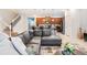 Comfortable living room area with open floor plan, staircase, and modern furnishings at 8879 Geneve Ct, Kissimmee, FL 34747