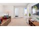 Spacious carpeted loft area featuring a comfortable leather couch and large flat-screen television at 8879 Geneve Ct, Kissimmee, FL 34747