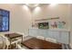 Welcoming meeting room featuring dark wood tables, white chairs, and accent artwork at 8879 Geneve Ct, Kissimmee, FL 34747