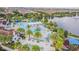 Aerial view of a community pool and lazy river surrounded by lush landscaping at 8879 Geneve Ct, Kissimmee, FL 34747