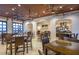 A restaurant with tables, chairs, ceiling fans, a bar area, and televisions at the ready for community residents at 8879 Geneve Ct, Kissimmee, FL 34747