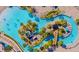 Overhead view of a community lazy river with bridge, waterslide, and tropical landscaping at 8924 Azalea Sands Ln # 8924, Davenport, FL 33896