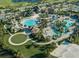 Aerial view of resort-style amenities including multiple pools, clubhouse, beach volleyball court, and lush landscaping at 8924 Azalea Sands Ln # 8924, Davenport, FL 33896